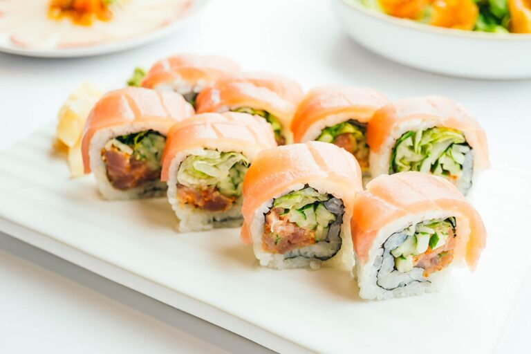 Crazy Salmon Roll | Raw salmon, white tuna, cucumber, avocado, masago inside out topped with tuna, sesame seed and spicy mayo | Saka - Original Asian Kitchen